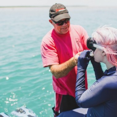 a person holding a fish in the water