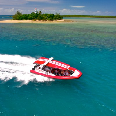 a man riding on the back of a boat in a body of water