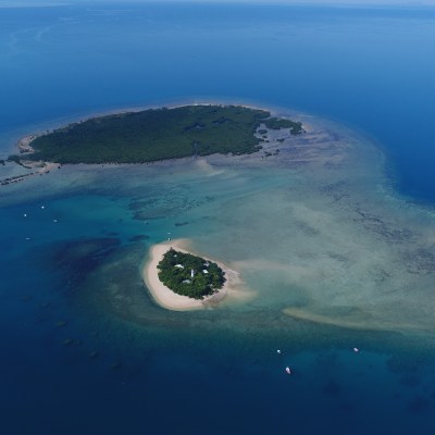 Aerial view of two small islands surrounded by blue ocean.